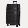 Three-quarter angled view of the Optima Expandable Large Check-in Spinner in Black, showcasing the sleek, ribbed hardside shell, Travelpro branding, and smooth-rolling spinner wheels.