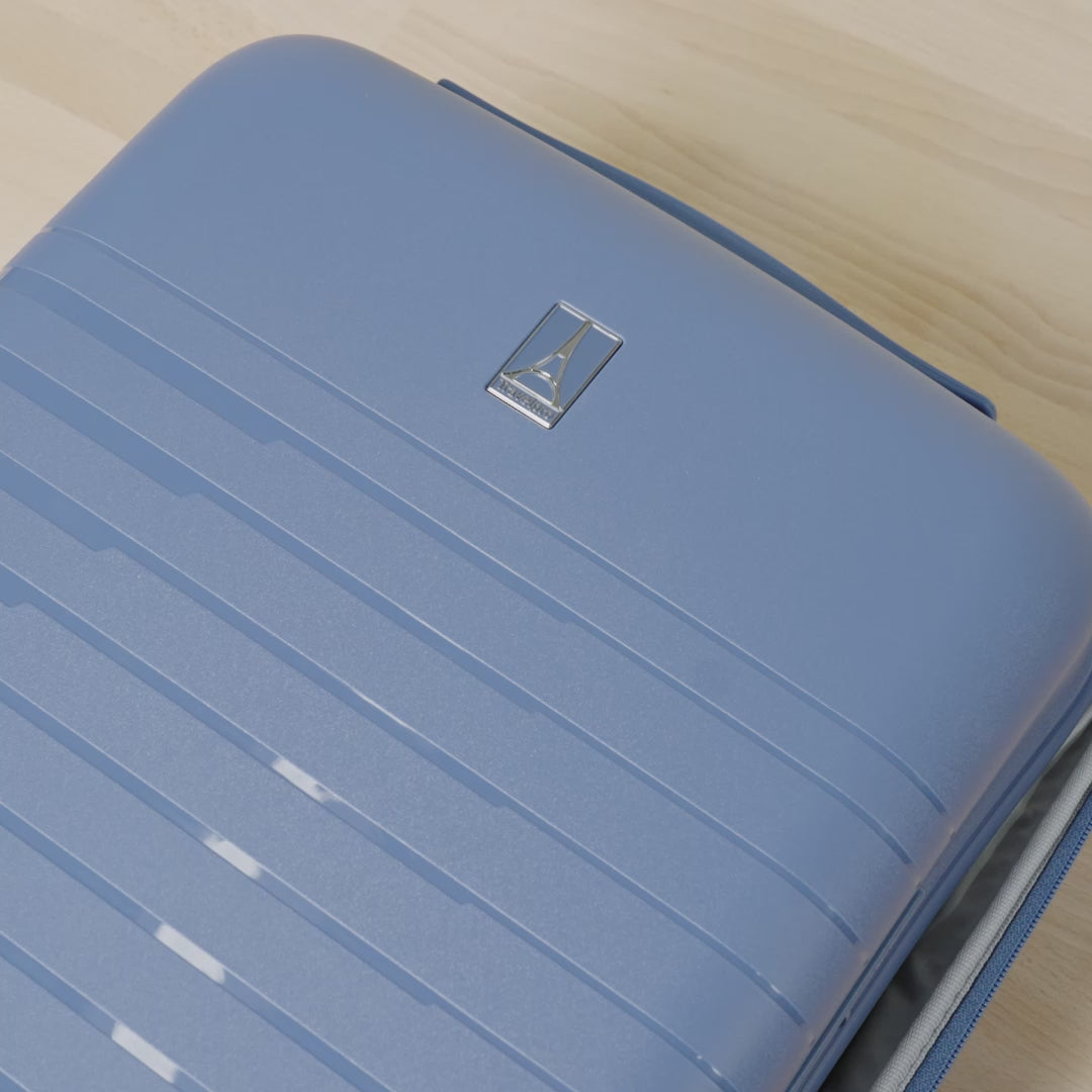 Close-up product demonstration video of the Travelpro Optima Expandable Spinner in Horizon Blue, highlighting the interior organization, zippered mesh divider, and compression straps for efficient, organized packing.